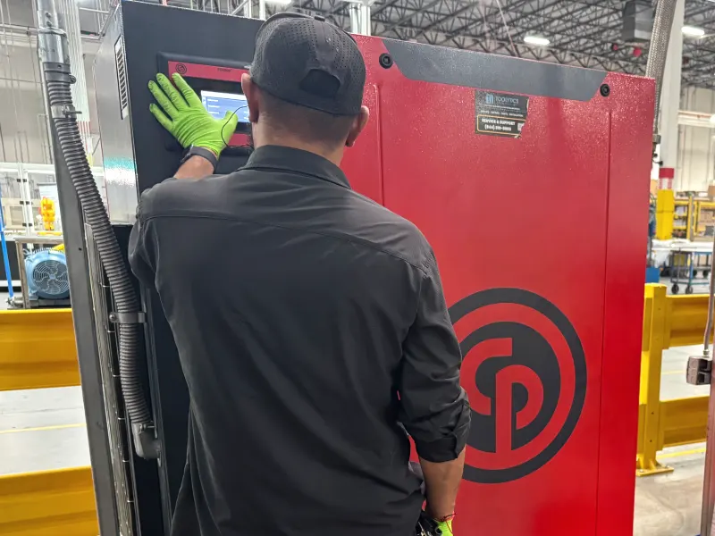 Toolytics technician checking the controller on a Chicago Pneumatic rotary screw compressor