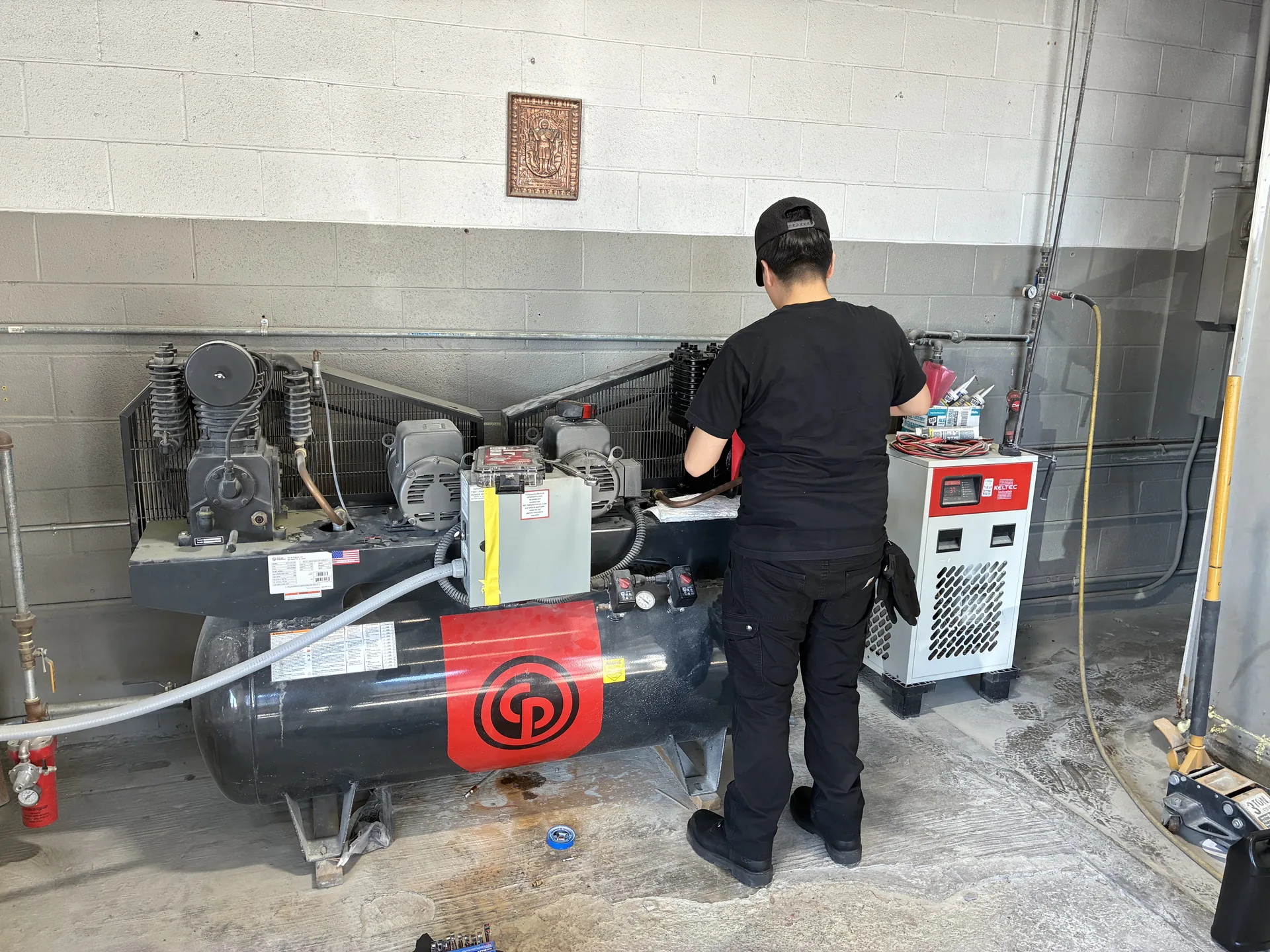 Toolytics Industrial technician servicing a Chicago Pneumatic duplex compressor system